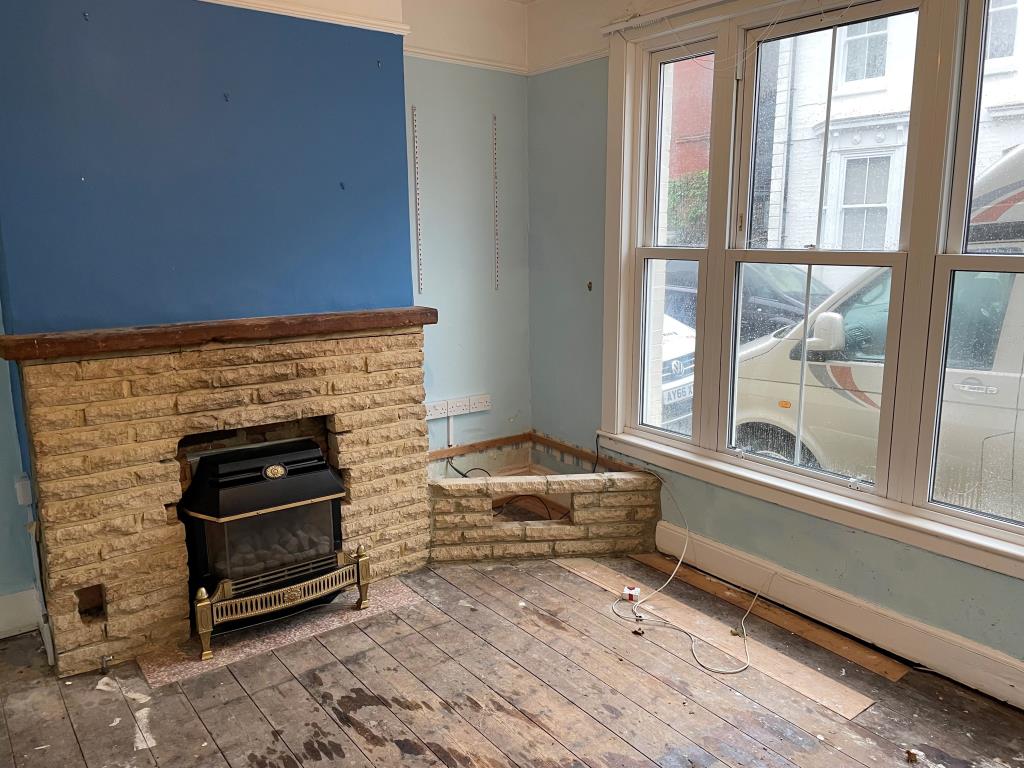 Lot: 109 - HOUSE IN NEED OF REFURBISHMENT AND REPAIR - Living room with fireplace and wood floors